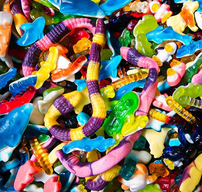 Assorted colorful gummy candy mix with worms, sharks, and animal shapes