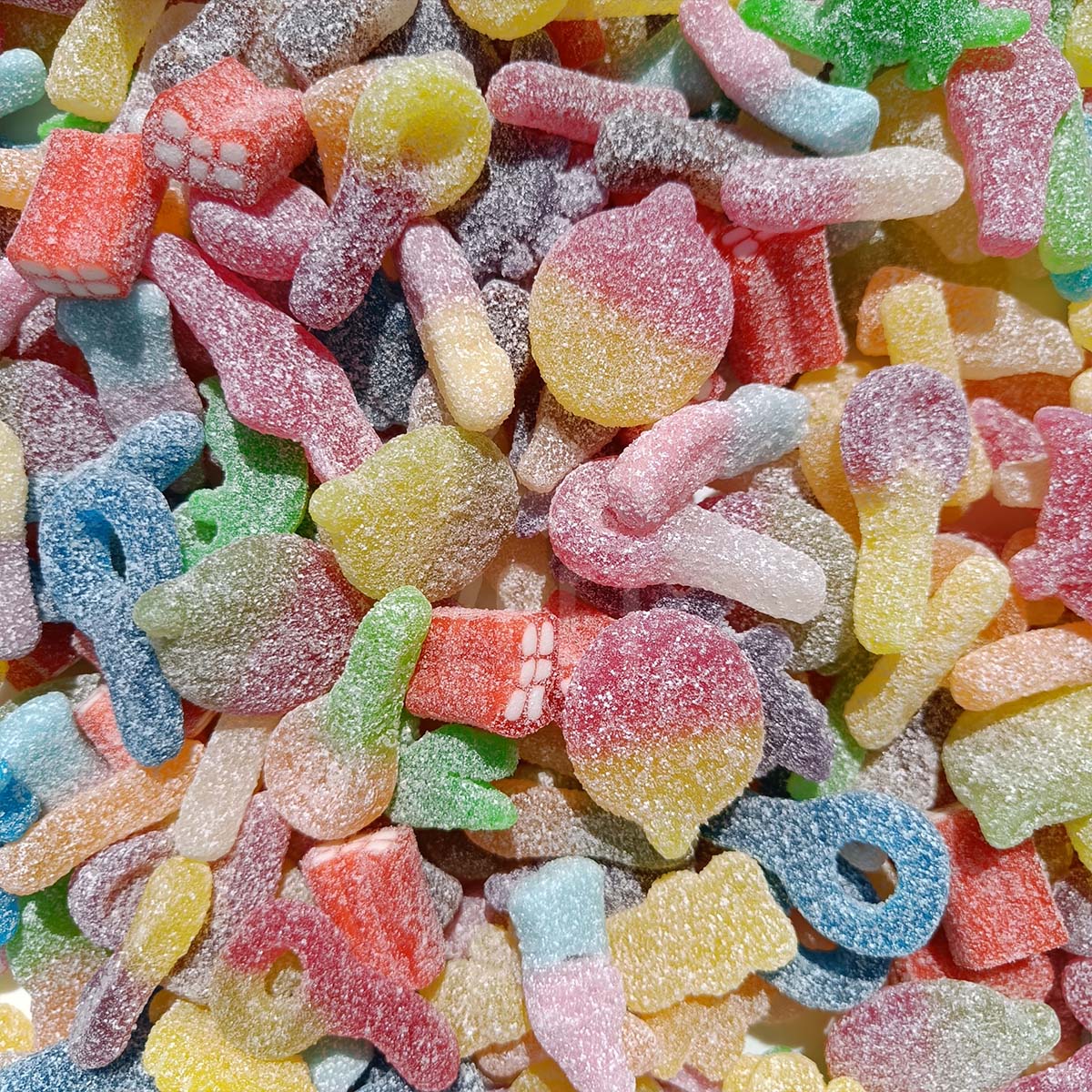 Assorted colorful sour gummy candies with sugar coating, close-up view.