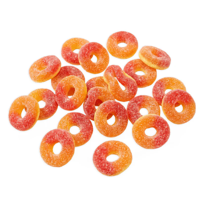 Colorful peach rings from Trolli, featuring a chewy gummy texture and peach flavor, displayed on a white background.